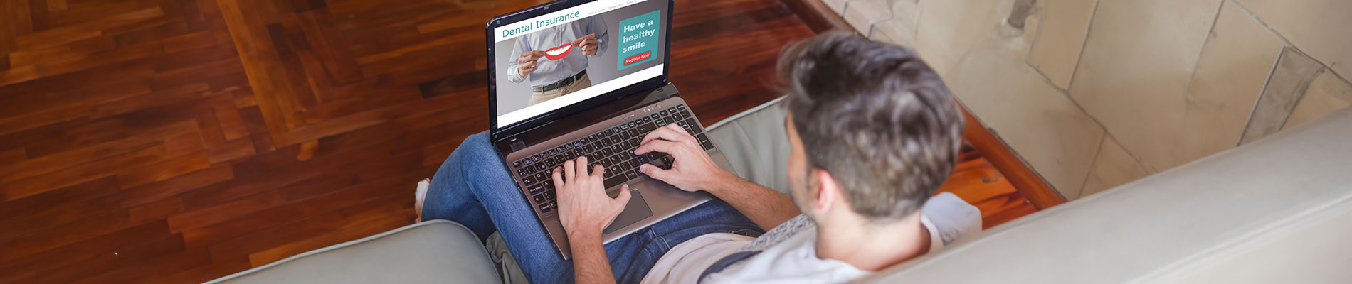 The image depicts a person using a laptop while seated on a couch, with the screen displaying what appears to be a website or application.